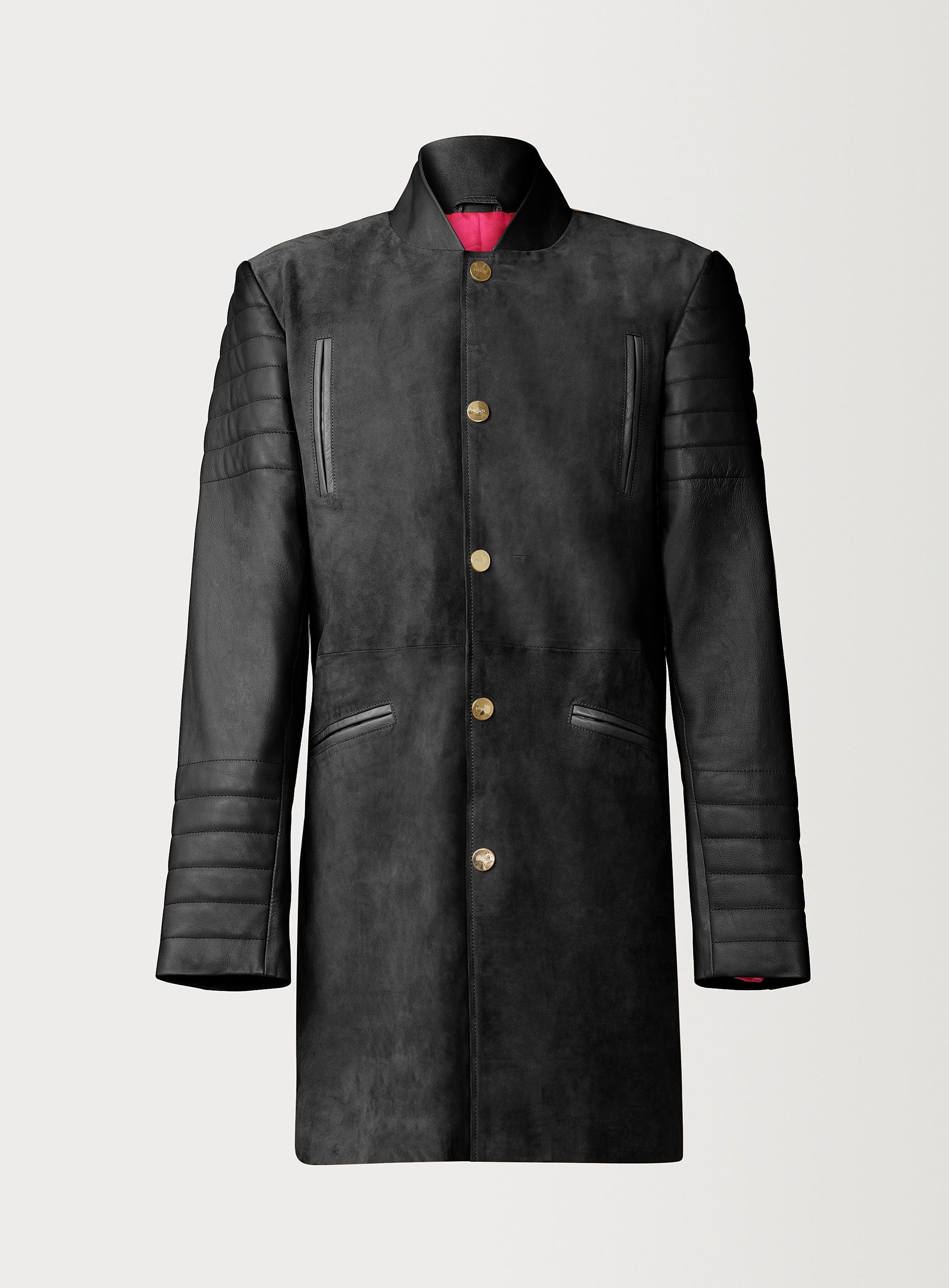 A Beautiful Black Suede Trench Coat, created by designer brand PRSVR. The PRSVR Lab Coat has a suede Body, and lambskin leather sleeves that show off a padded ribbed design on the shoulder and wrist of the sleeve. 