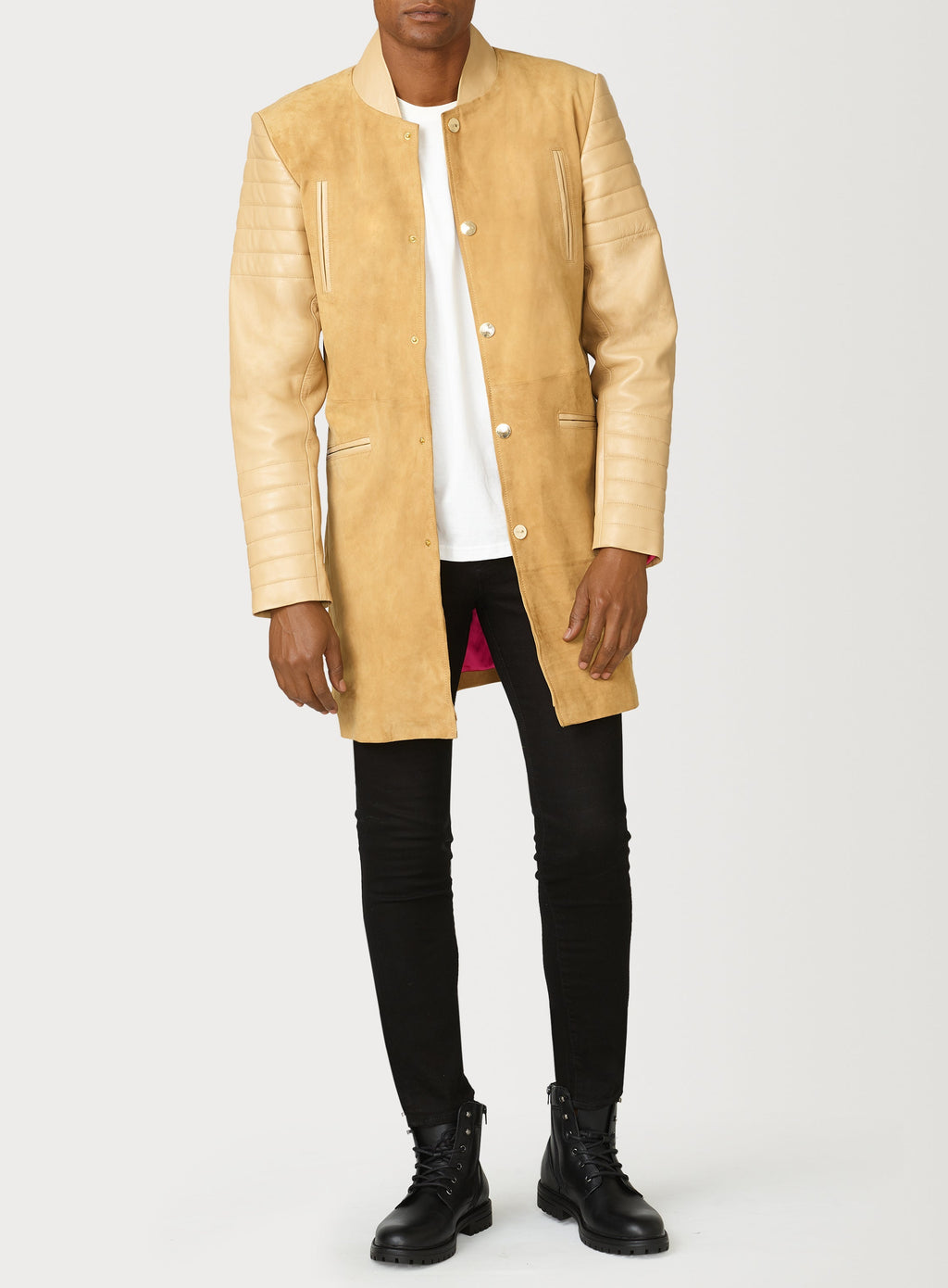 A Beautiful Suede Trench Coat, created by designer brand PRSVR. The PRSVR Lab Coat has a suede Body, and lambskin leather sleeves that show off a padded ribbed design on the shoulder and wrist of the sleeve. 