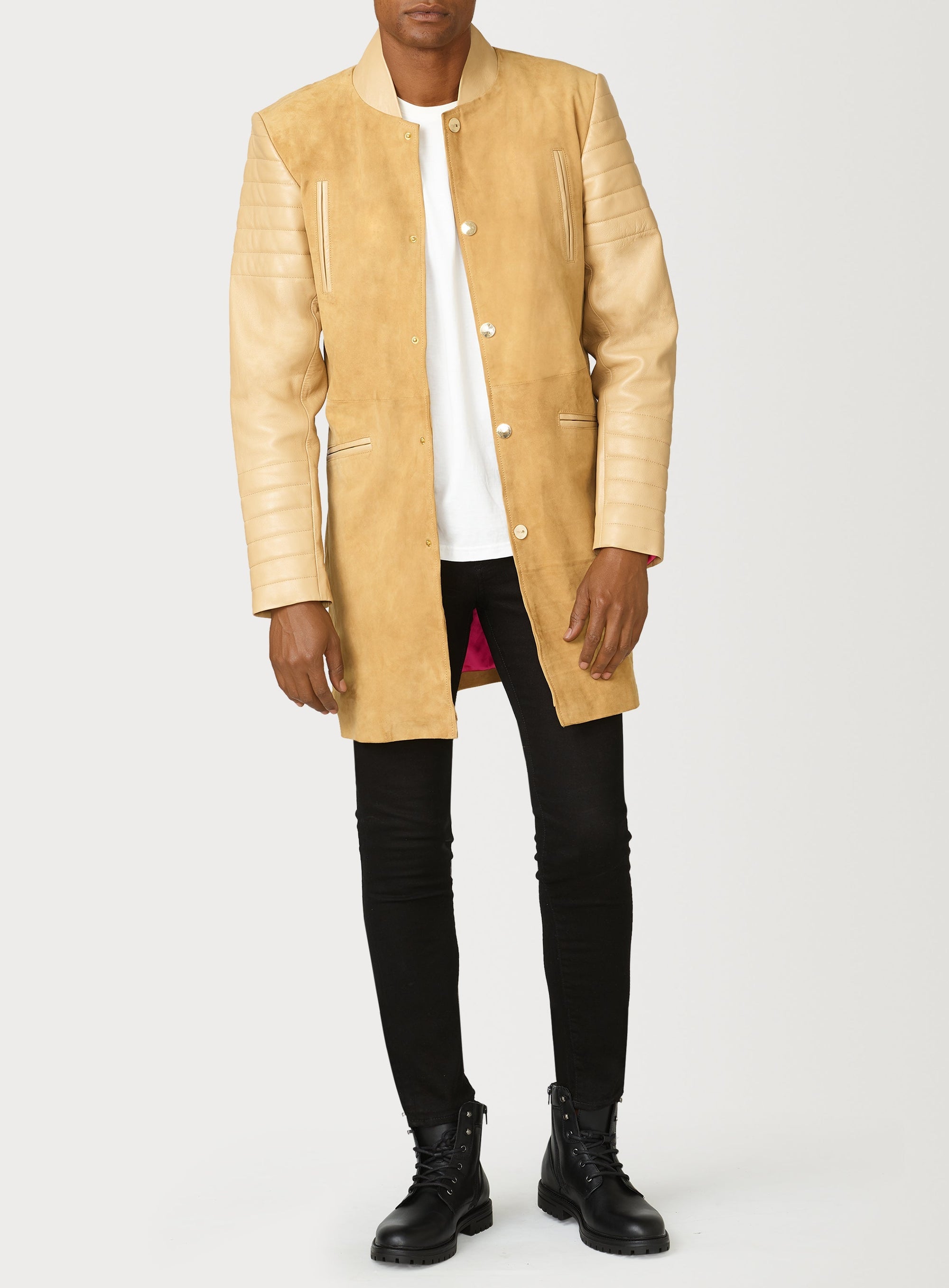A Beautiful Suede Trench Coat, created by designer brand PRSVR. The PRSVR Lab Coat has a suede Body, and lambskin leather sleeves that show off a padded ribbed design on the shoulder and wrist of the sleeve. 